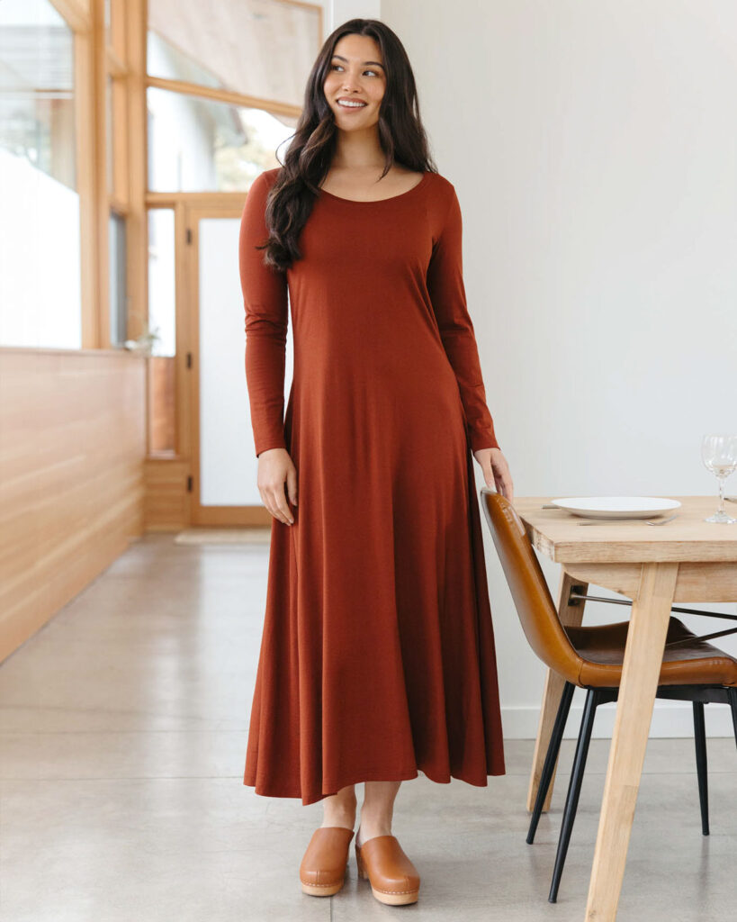 A female model in a long maroon dress