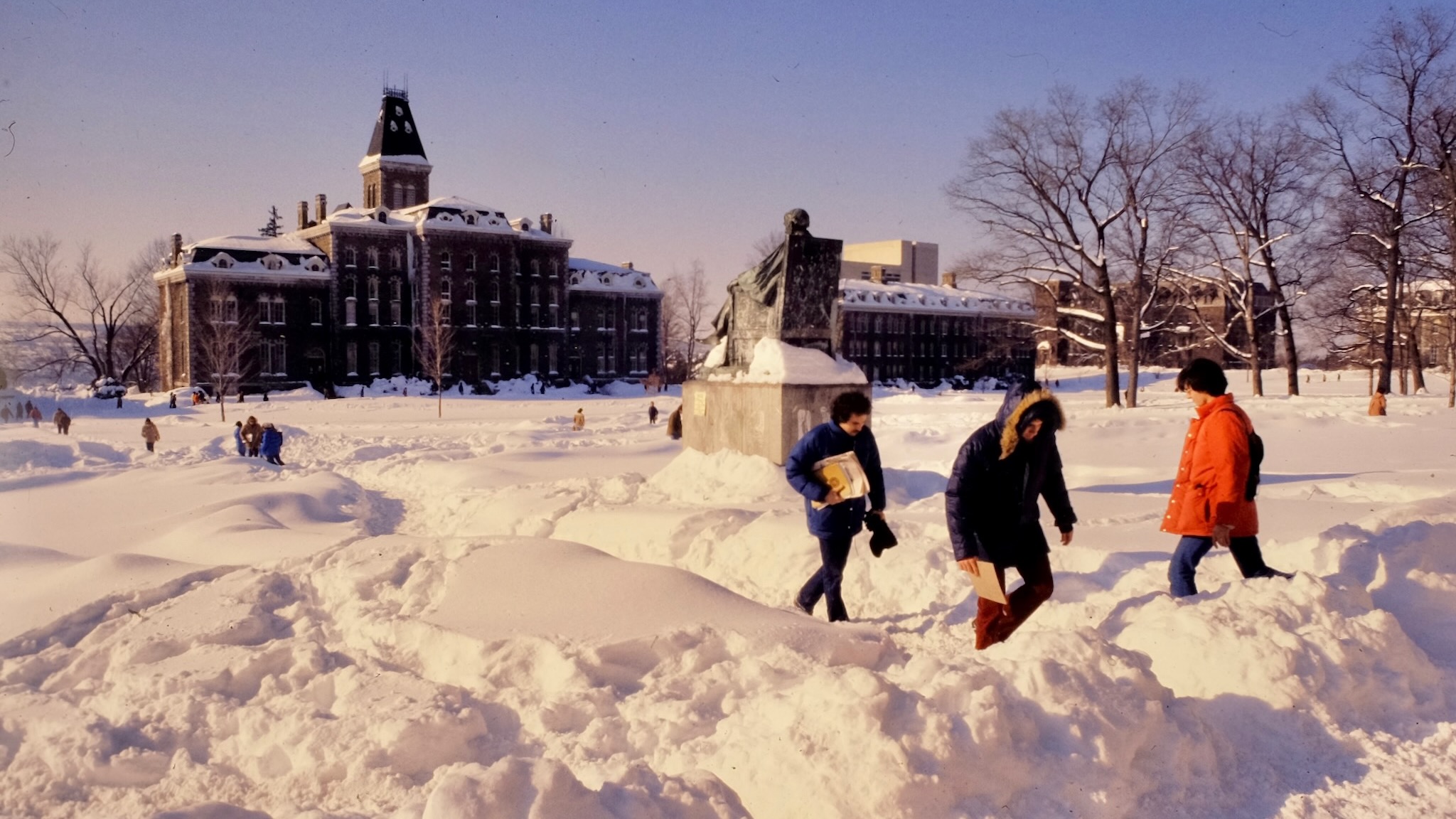students traverse deep snow across the Arts Quad in the early 1980s