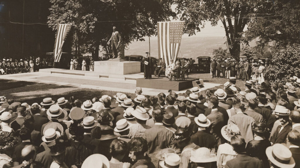 A crowd watches the dedication of the Ezra Cornell statue on the Arts Quad