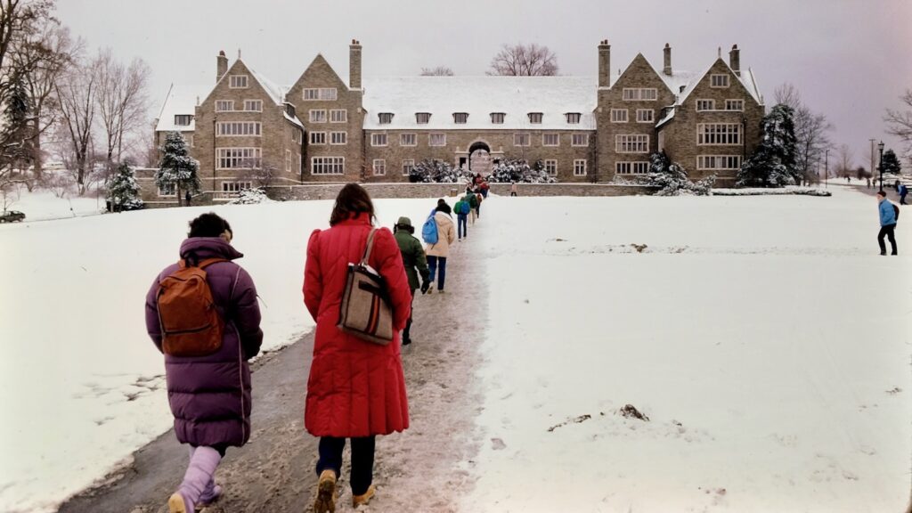 students trek toward Balch Hall and North Campus in the snow in 1984
