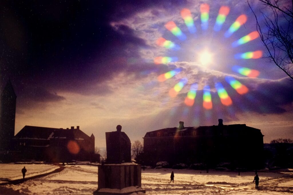 a snowy Arts Quad and the A.D. White statue are seen through a starburst filter in a photo from 1982