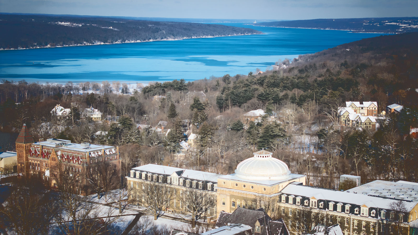 Sibley Hall on a snowy morning in January with Cayuga Lake in the background.