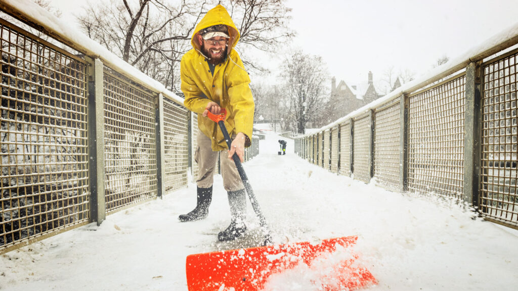 Employees clearing snow from the Beebe Dam bridge.