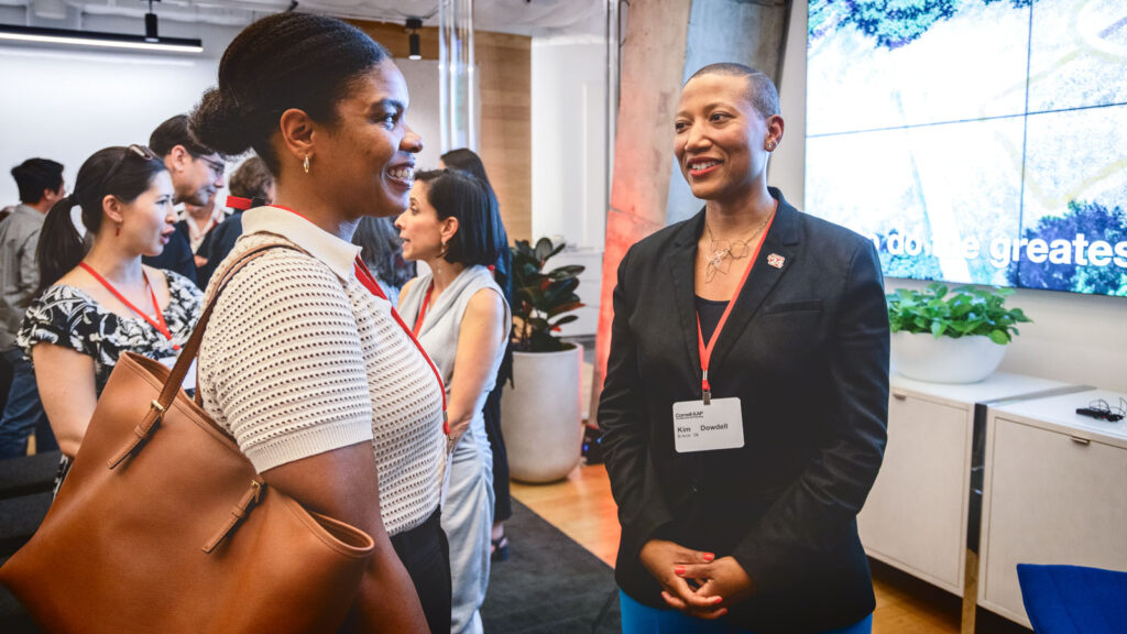 Kim Dowdell, right, chats with an alum at a College of Architecture, Art, and Planning alumni reception in 2024