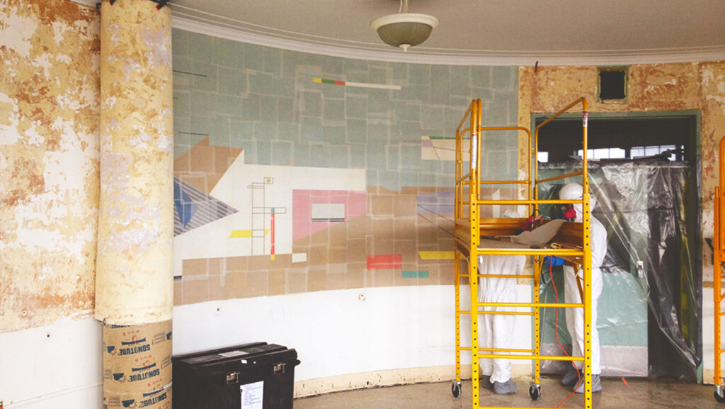 Image of the Bolotowsky mural being removed from a wall in the former Goldwater Hospital