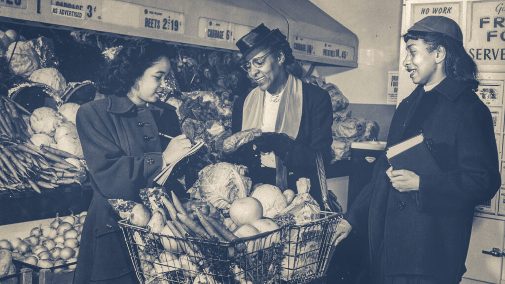 Flemmie Kittrell is pictured in a grocery store in Washington, DC, between two women who are shopping in the produce section