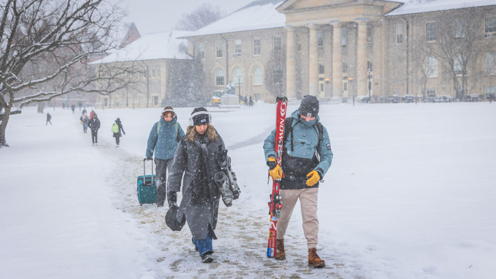 Students walk on the Arts Quad during a snowstorm