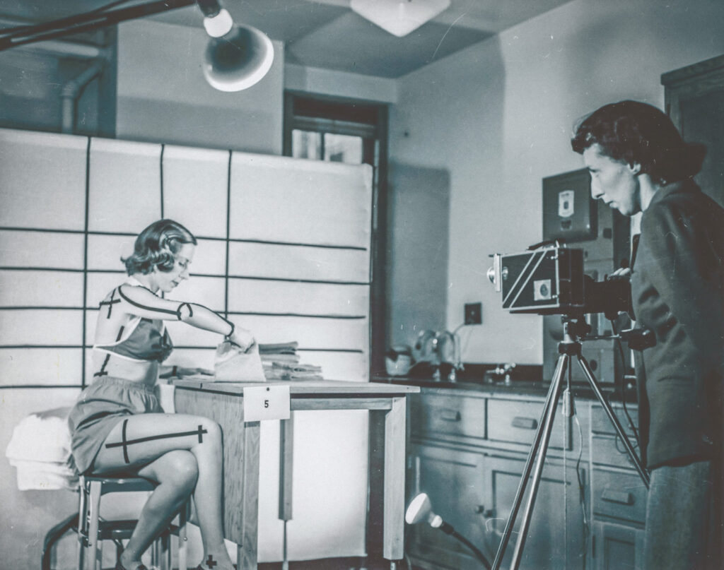 a home economics student is filmed for an ergonomics study on optimal movements while folding laundry