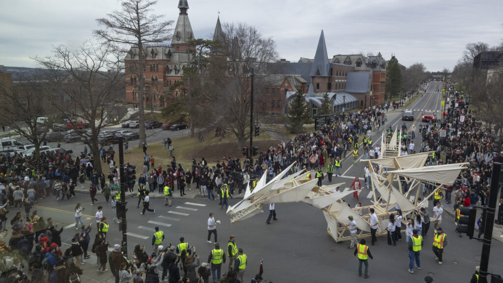 view from an upper floor of Duffield Hall as the dragon turns the corner by Sage Hall during Dragon Day 2025
