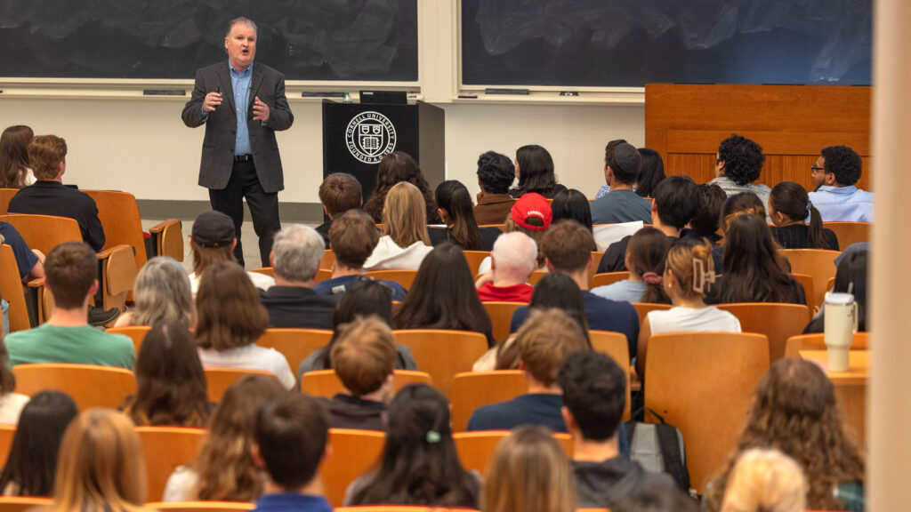 Head Hockey Coach Mike Schafer speaks to a crowded auditorium in Baker Hall as his “Last Lecture” on Wednesday, April 23, 2025. (Ryan Young / Cornell University)