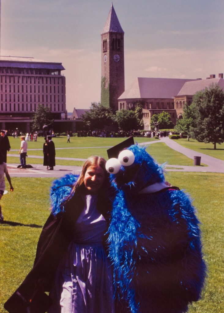 A grad on the Arts Quad with Cookie Monster