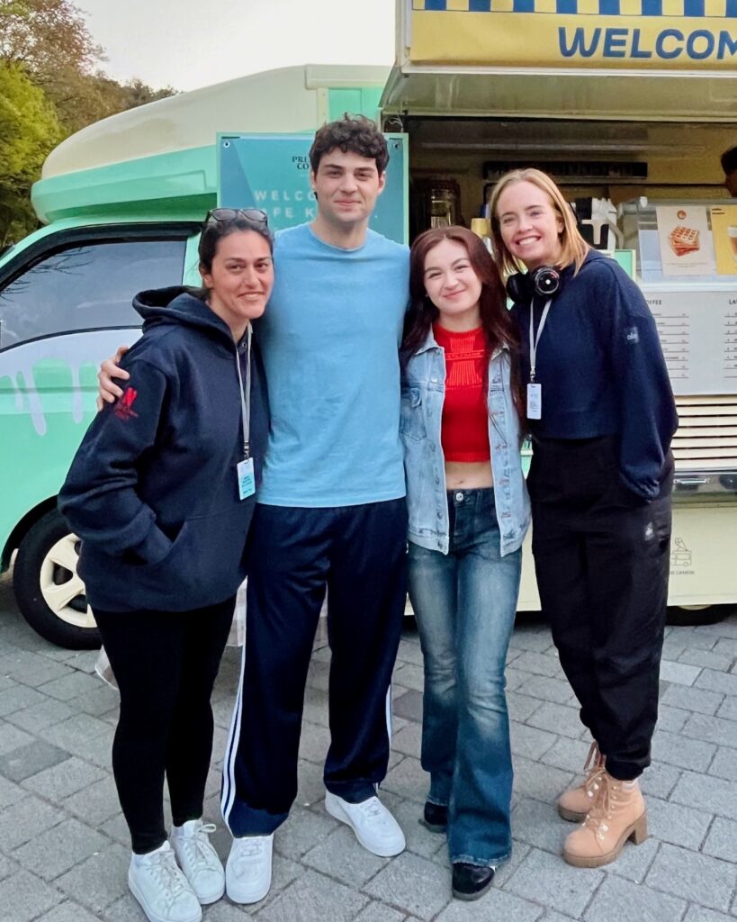 Jessica O'Toole on set with actors from the XO Kitty series, including Noah Centineo.