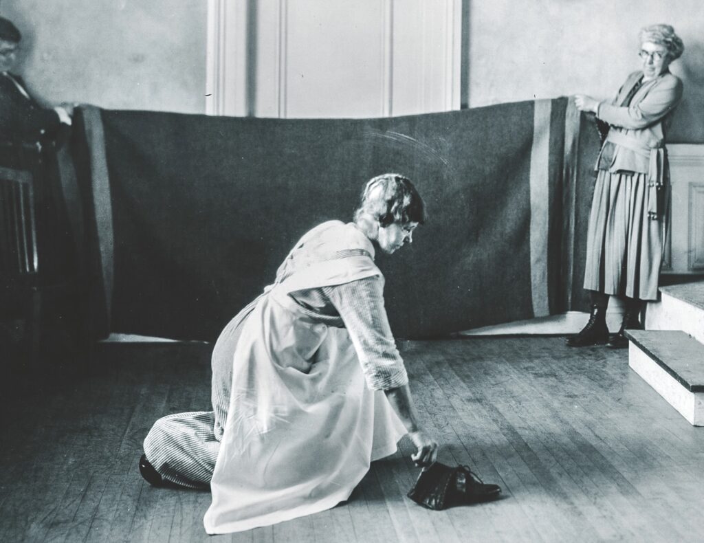 part of a 1921 home economics photo series showing correct posture for various forms of housework