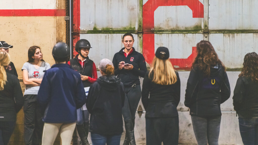 Joanna Novakovic talks to her team before a show in 2019 in the Oxley Equestrian Center.