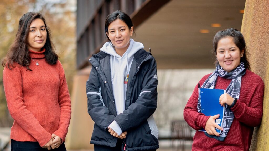 From left, Diana Ayubi, Tamana Ahmadi, and Simah Sahnosh walk outside Uris Hall.