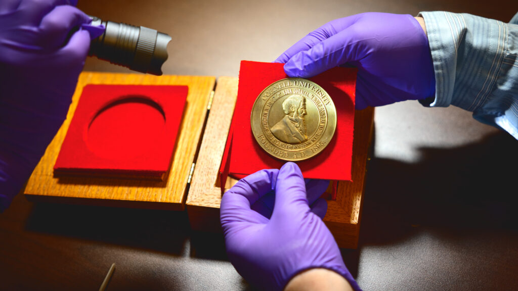 The two-and-a-half-inch Great Seal medallion is examined by Cornell University Library archivists in a secure location on campus
