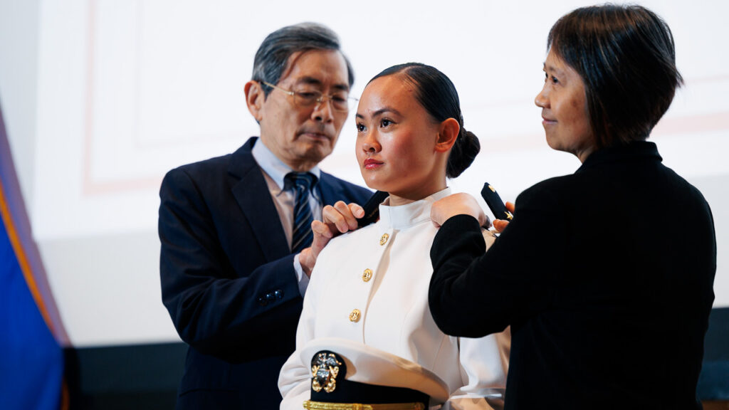 Officer Rose Jou receives her pins during the ROTC Tri-Service Commissioning Ceremony in Statler Auditorium.