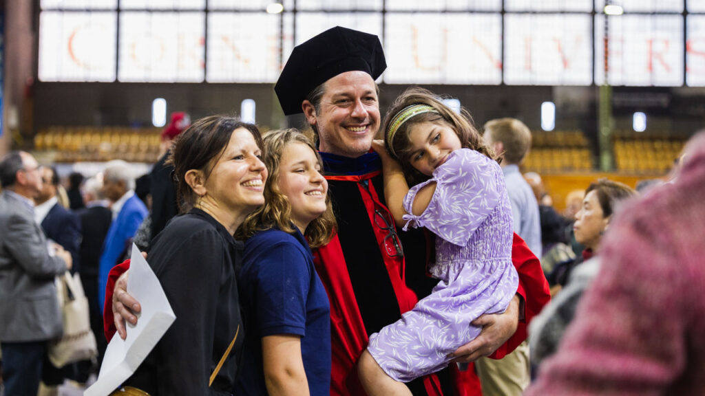 A Ph.D. graduate and his family smile for a photo during the 2025 Ph.D. Recognition Ceremony.