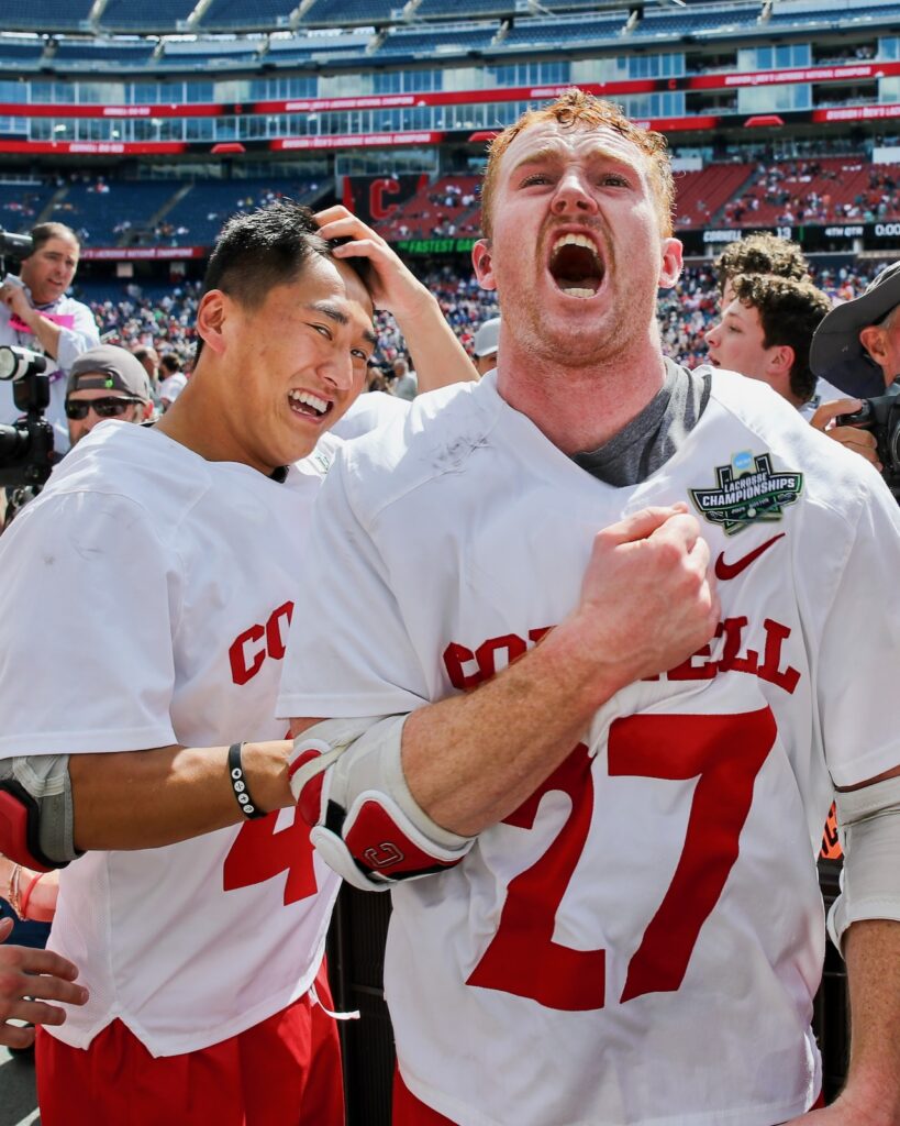 Two Cornell lacrosse players celebrate after the game