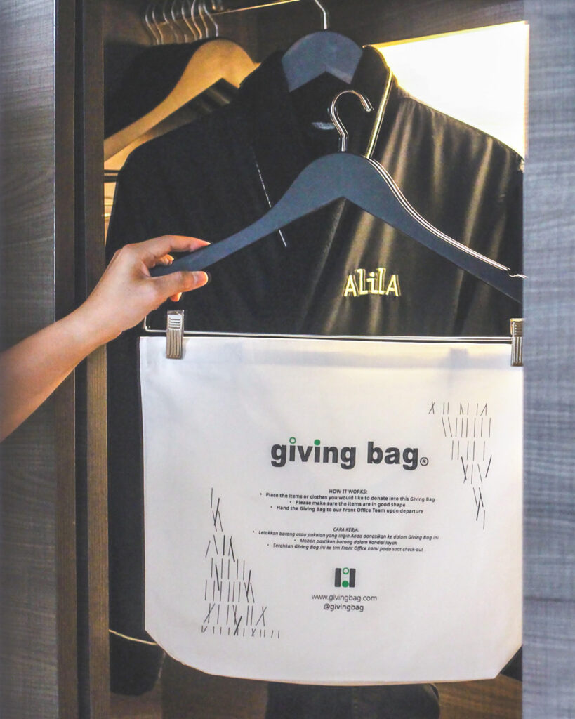 A white giving hangs in the open closet in a hotel room in the hotel Alila SCBD Jakarta.