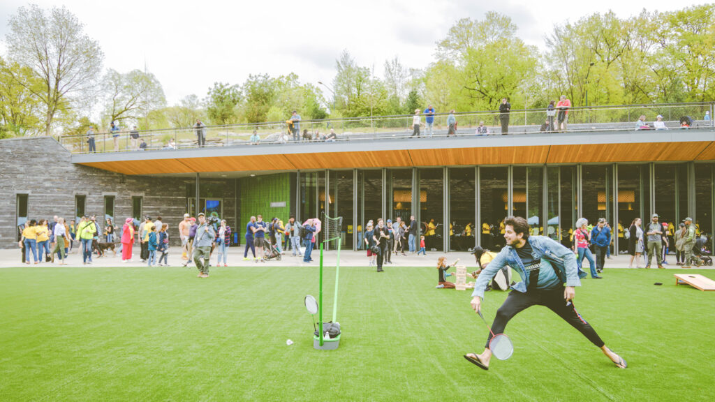 People enjoy playing on the green and exploring the Davis Center on its opening day in April in NYC