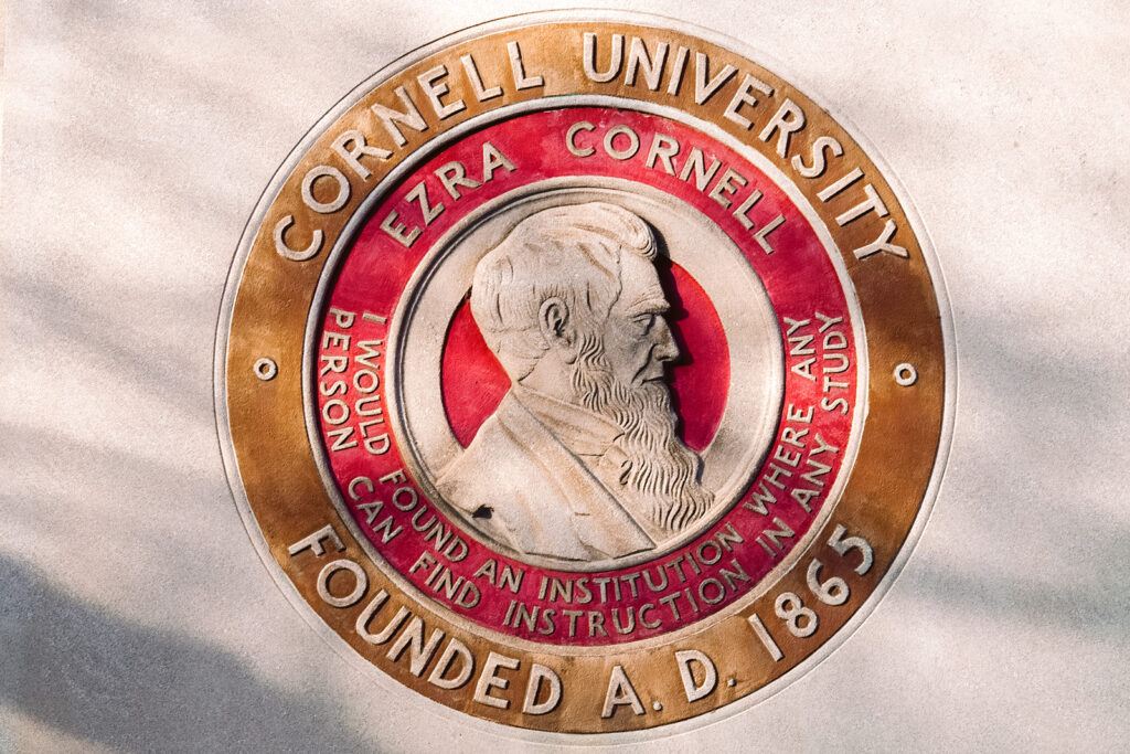 a large, stylized version of the Great Seal on the facade of Day Hall on campus