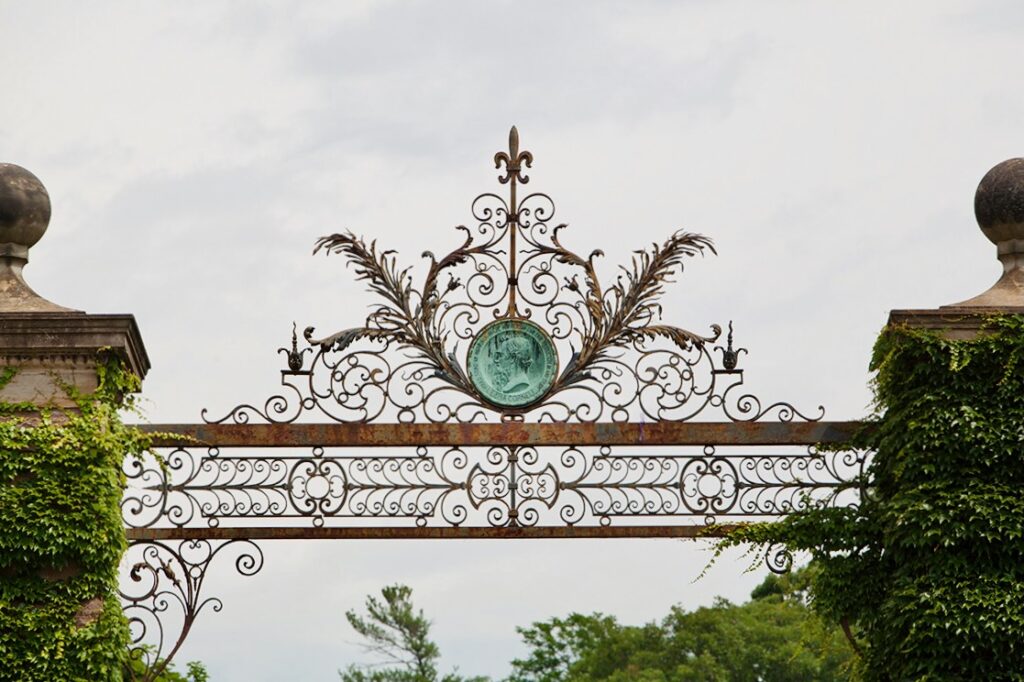 a portrait medallion of Ezra Cornell is set into the Eddy Gate in Collegetown, just outside the Cornell campus