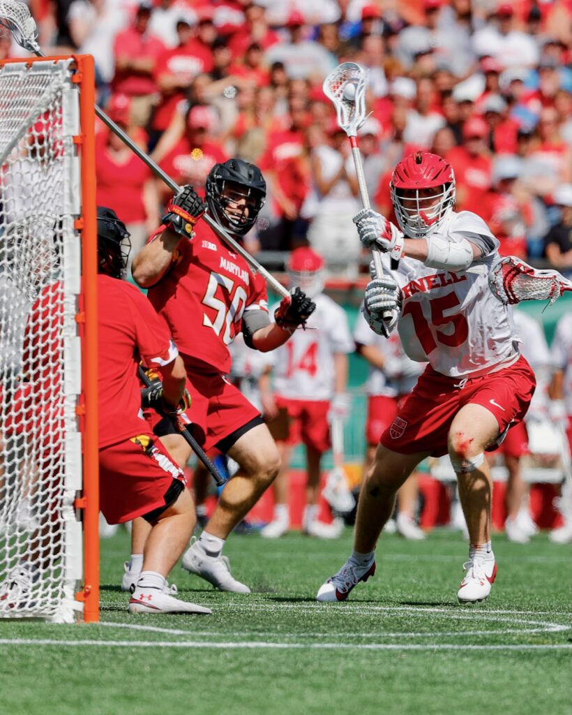 Cornell lacrosse player #15 shoots at a goal
