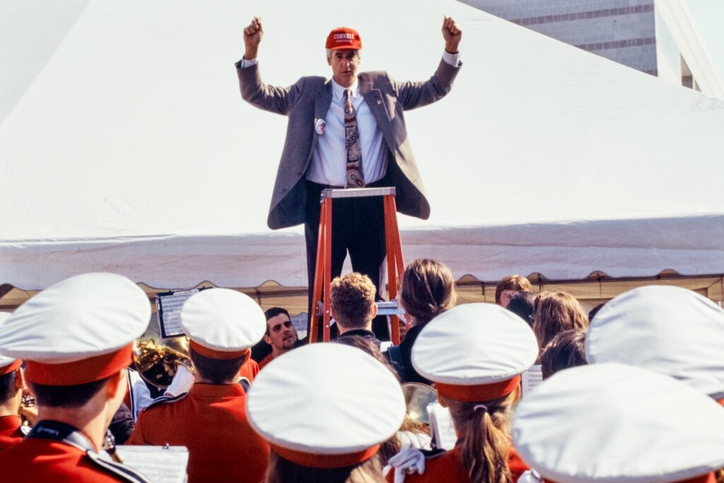Then-President Hunter R. Rawlings III, standing on a ladder, conducts the Big Red Band at Reunion 1996