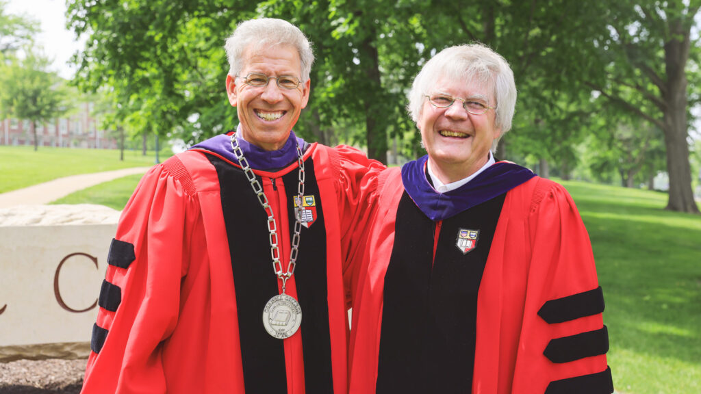 Cornell College President Jonathan Brand, JD ’96, poses with another transplant from the Hill, history professor Phil Lucas, PhD ’83, at a Cornell College commencement