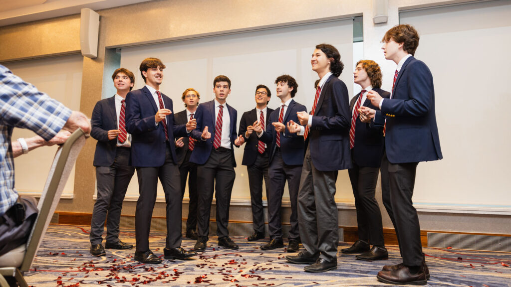 The Hangovers, a student-run a cappella ensemble, perform for guests at the Passing It Forward ceremony during Cornell Reunion in Statler Hall.