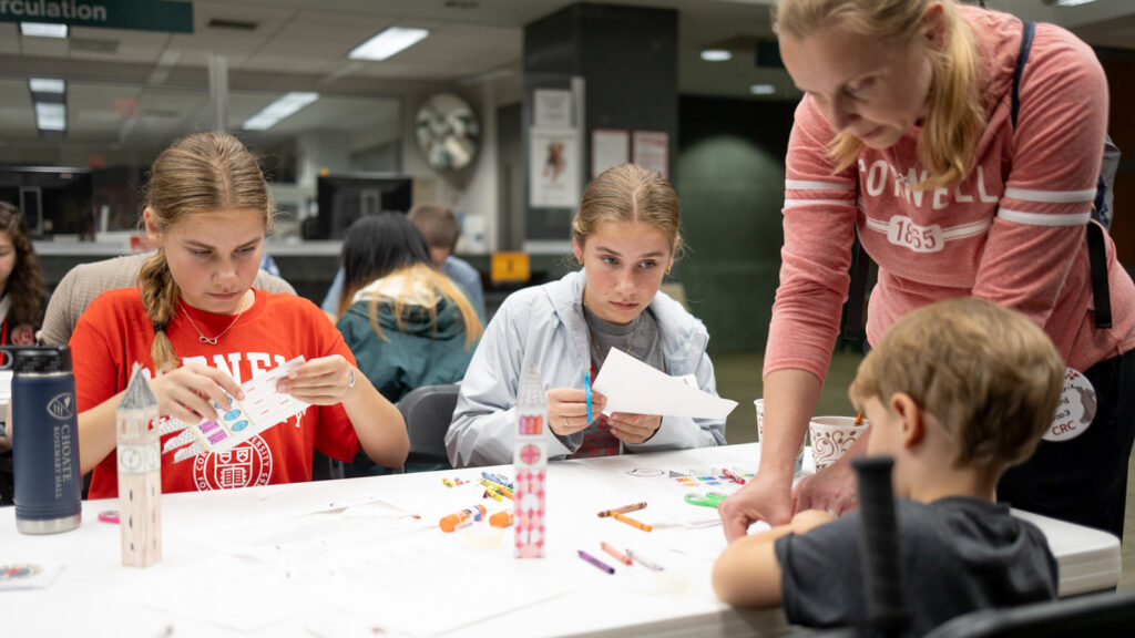 A family takes part in arts and crafts in the Catherwood Library in Ives Hall