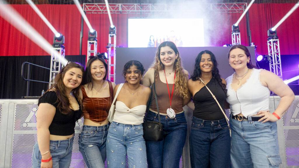 Six women pose in Barton Hall during Slope Day 2.020