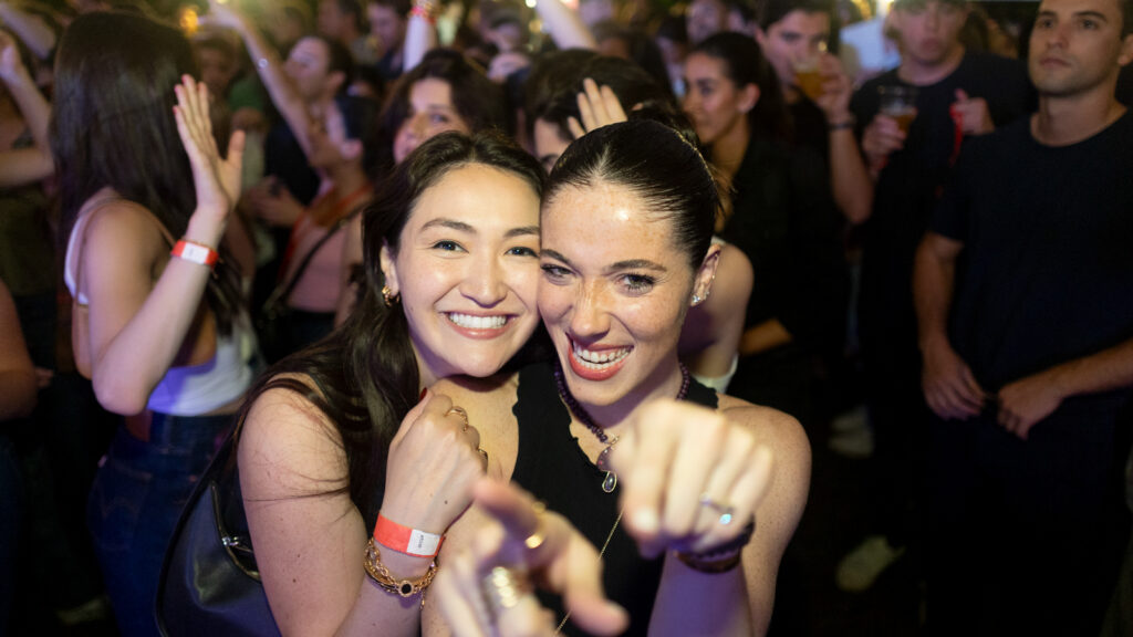 two women smile during the tent parties on the Arts Quad