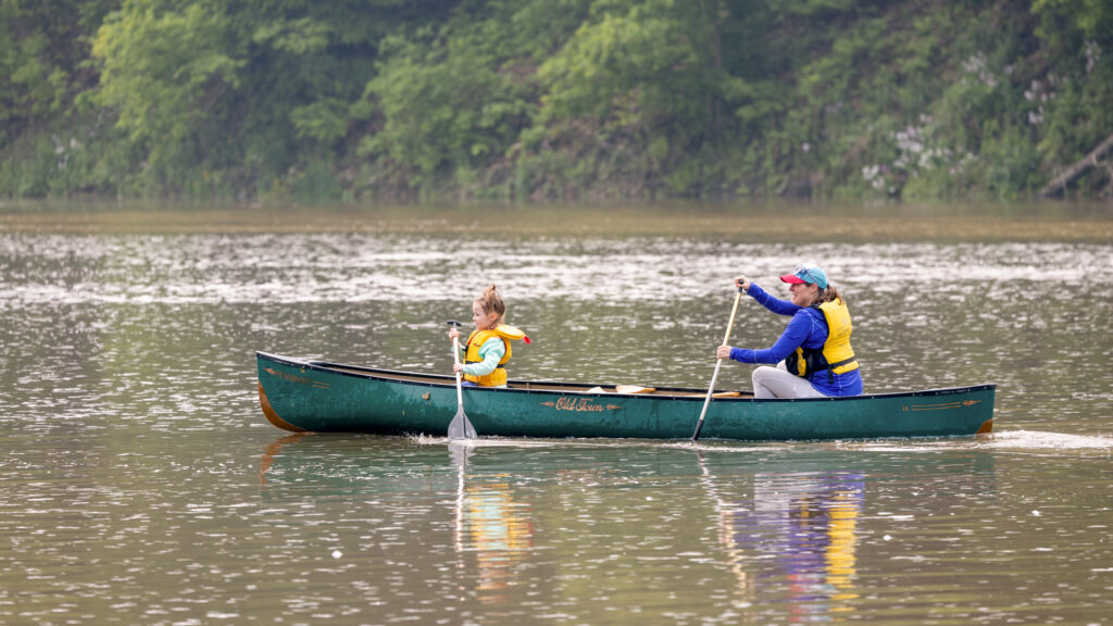 A woman and child canoeing on Beebe Lake