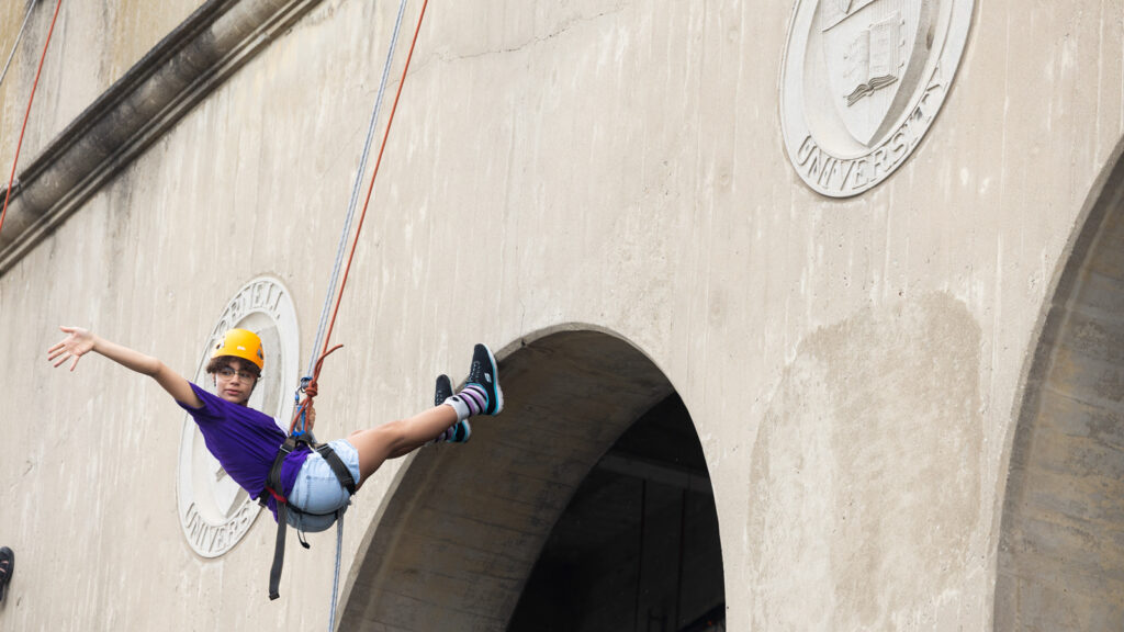 A child rappels down the outside of the Crescent