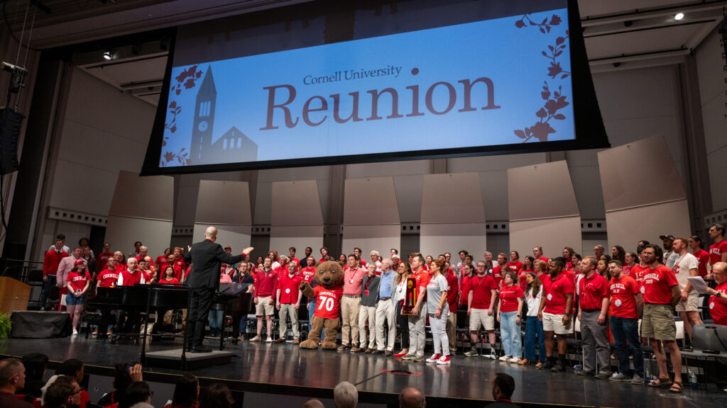 Cornellians gather onstage for Cornelliana Night in Bailey Hall
