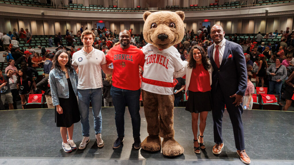 Cornell Alumni attend Olin Lecture in Bailey Hall featuring Olympians from left to right Karen Chen, Michael Grady, Chibi Okezi, Touchdown, Aditi Kinkhabwala, and Kevin Boothe
