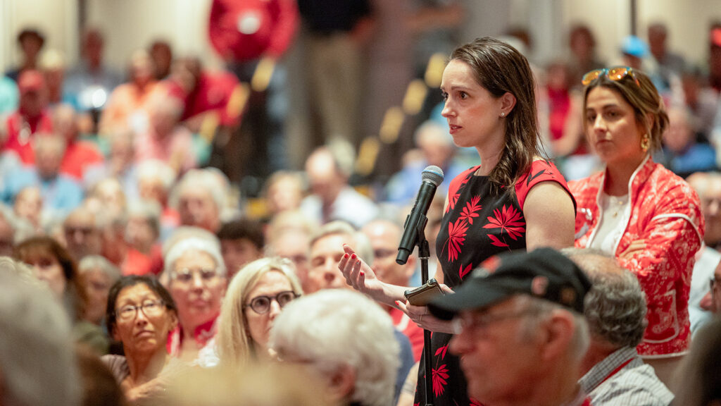 A woman asks a question at the State of the University Address