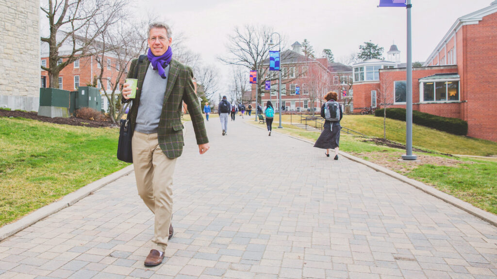Jonathan Brand, JD ’96, president of Cornell College, strolls on the Midwestern campus, coffee in hand