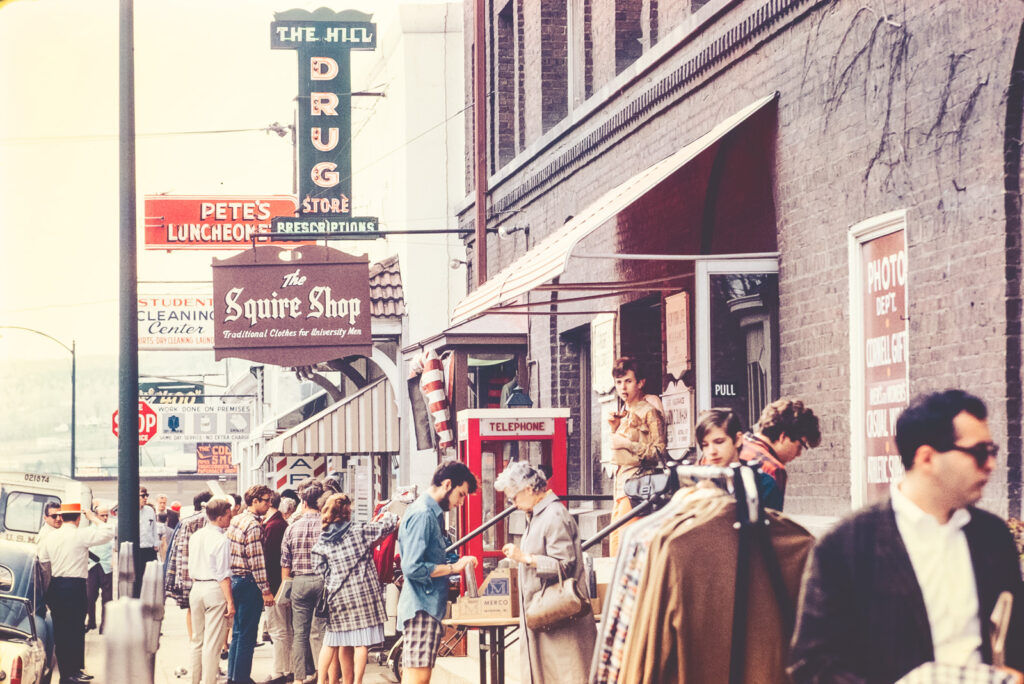 pedestrians browse merchandise during a sidewalk sale on College Avenue outside the Squire Shop, 1967