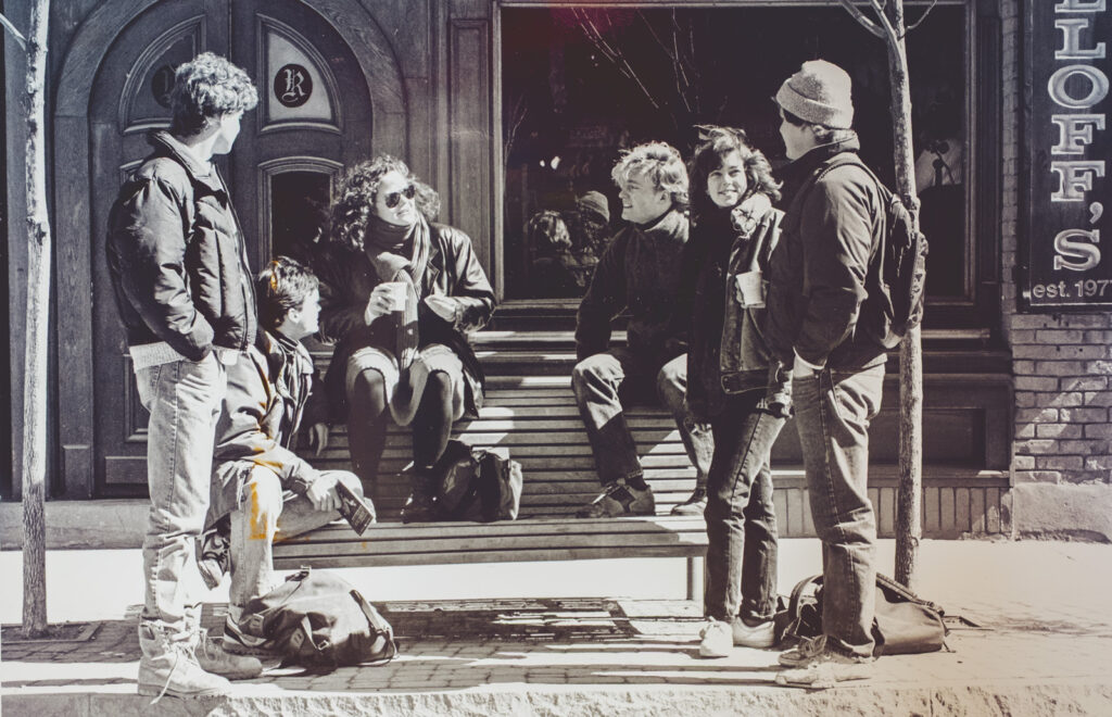Students gather on a bench on College Avenue outside Rulloff’s in the early 1980s
