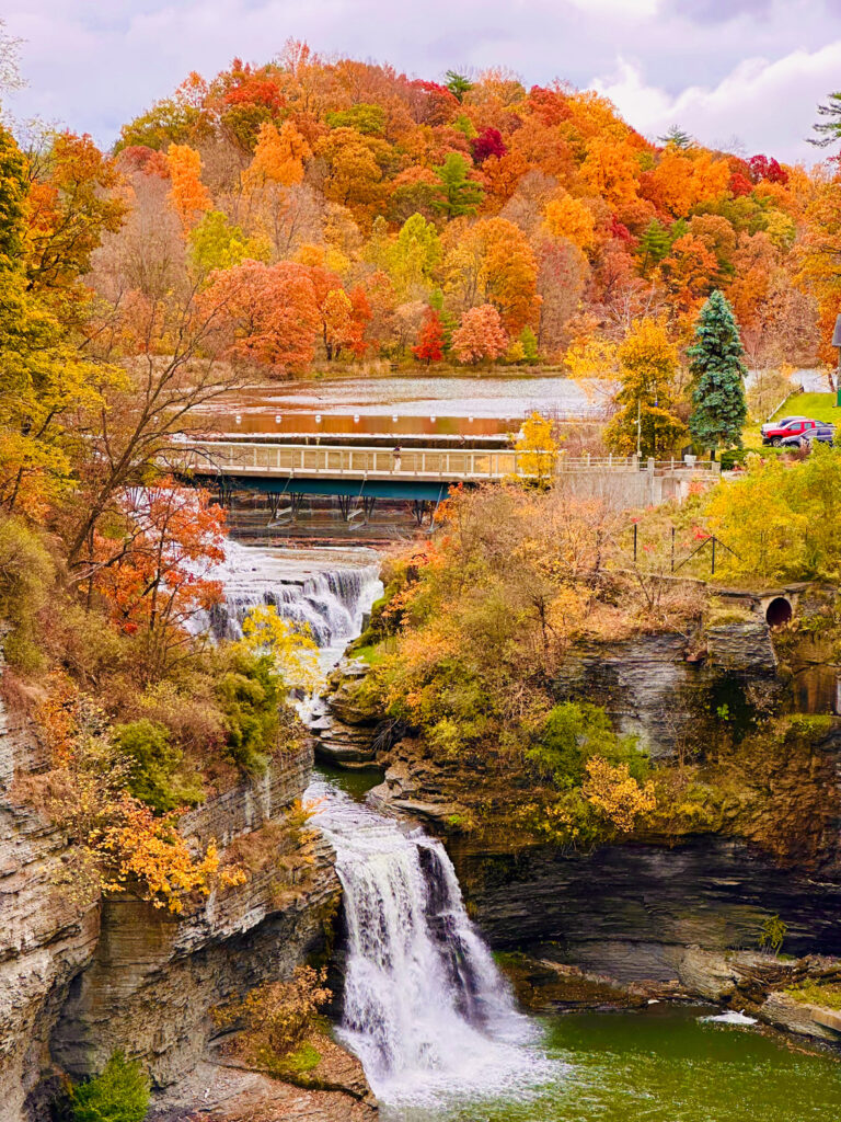 the falls downstream of Beebe Lake surrounded by fall foliage in hues of orange, red, and yellow