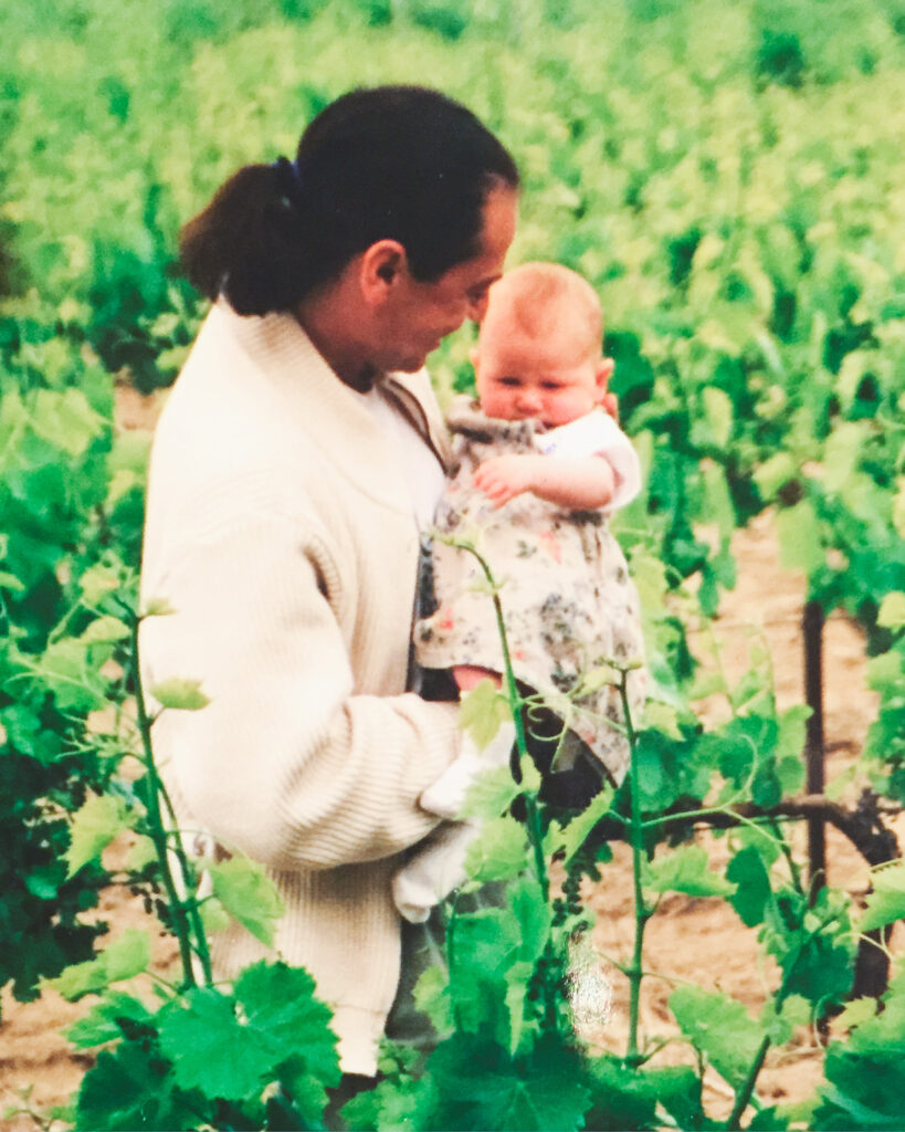 Victor Schwartz holding his baby daughter in a vineyard