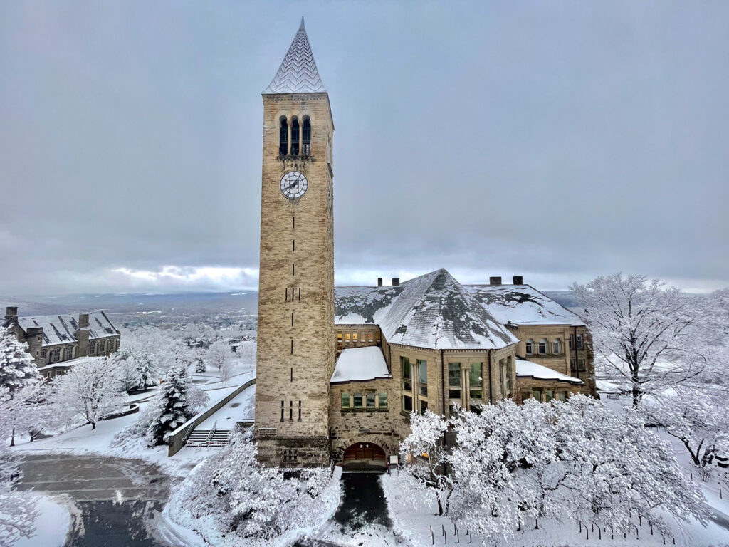 wide view of McGraw Tower, Uris Library, and their surroundings during the winter on a snow-covered campus