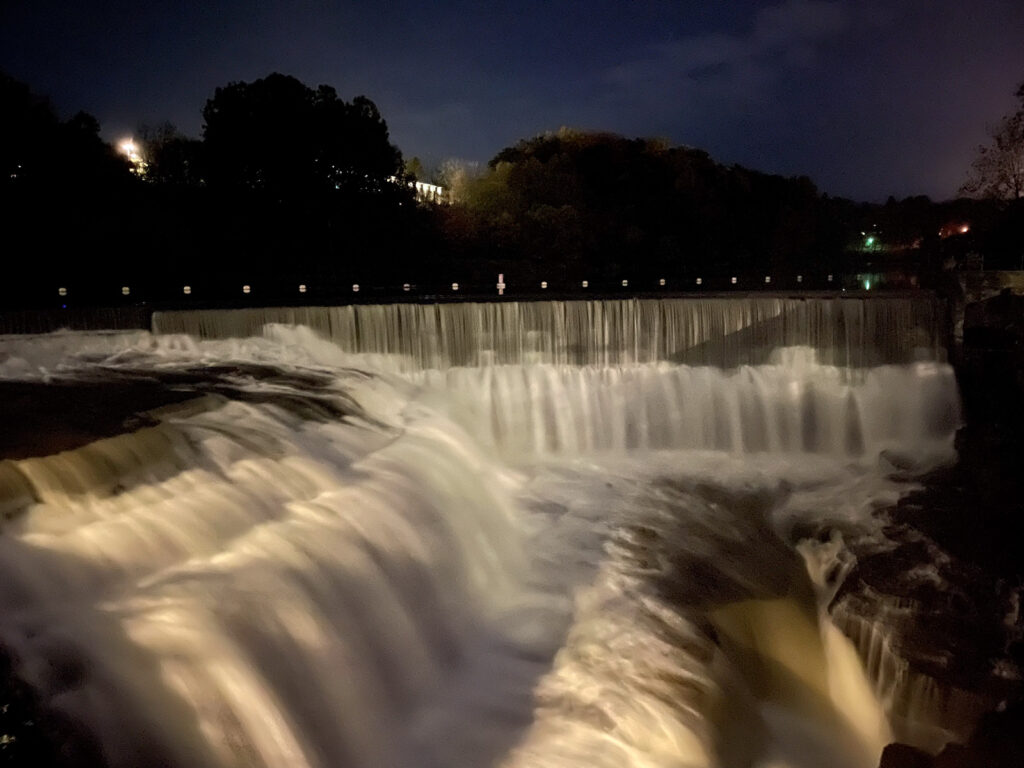 the falls by Beebe Lake viewed at night under a dark blue sky