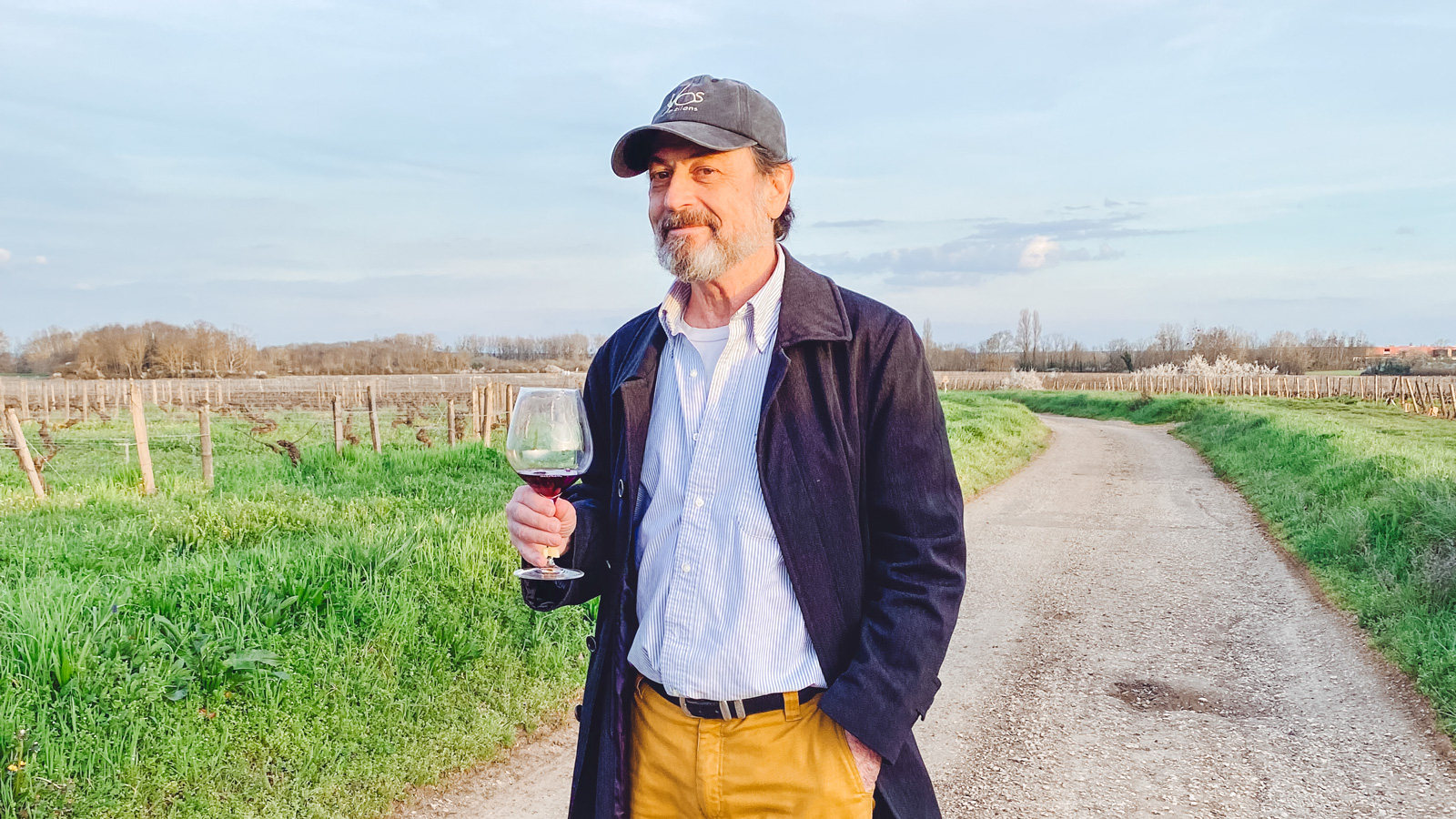 Victor Schwartz standing in a road holding a glass of wine