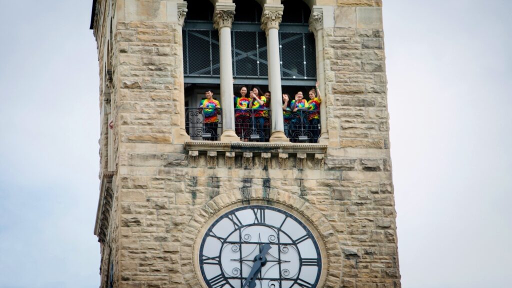 Cornellians in tie-dyed shirts gather at the observation deck of McGraw Tower to listen to a special Grateful Dead anniversary Chimes concert in 2017