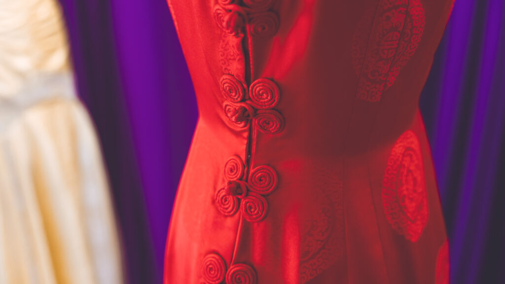 The side of the red dress made by Peggy Dunlop that shows the details of the frog closures.