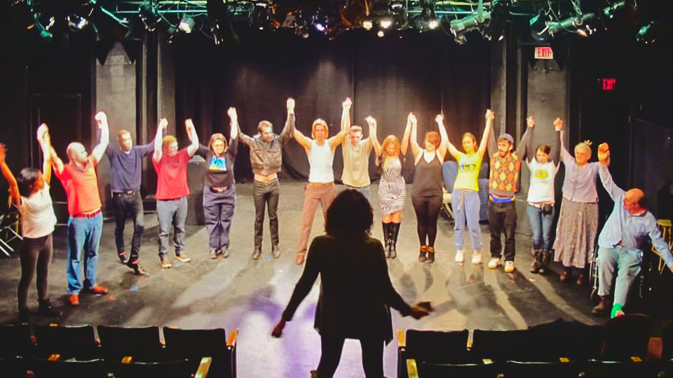 cast members on stage in the Risley Theatre
